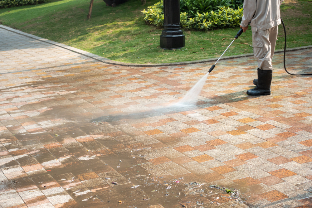 Power washing a brick paver patio